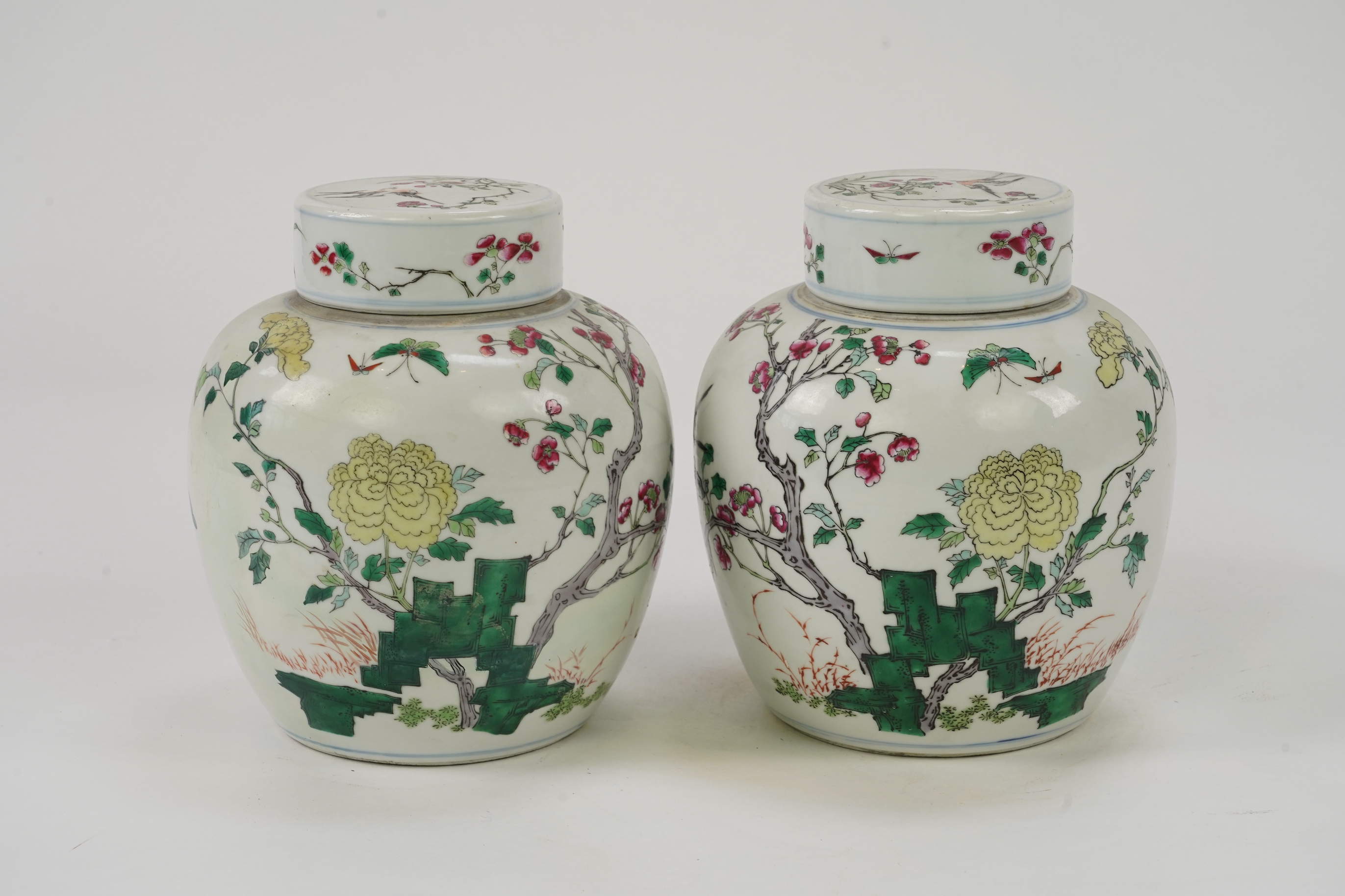 A pair of Chinese famille rose jars and covers, Kangxi mark but late 19th/early 20th century